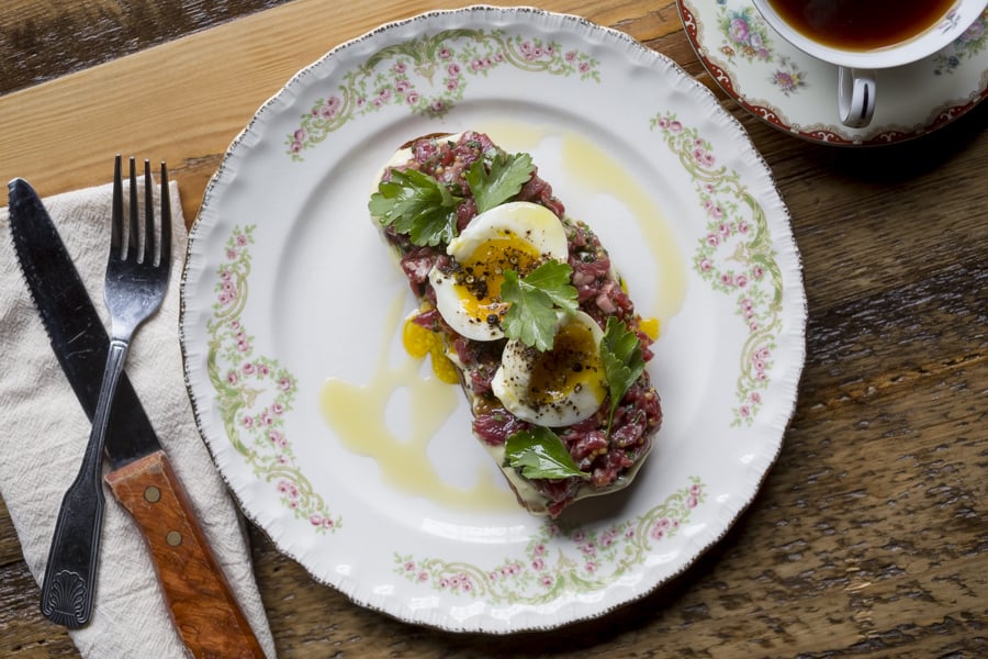 A plate of steak tartare and soft-boiled eggs