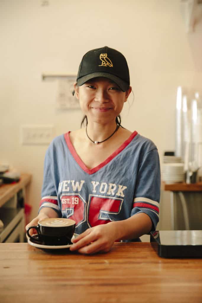 A barista serves a coffee