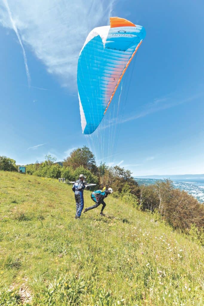 Instructing a paraglider before a jump