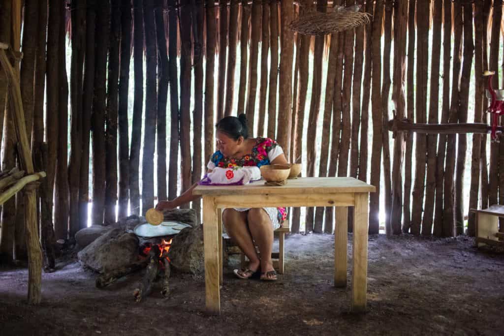 A woman cooking a Maya-style meal