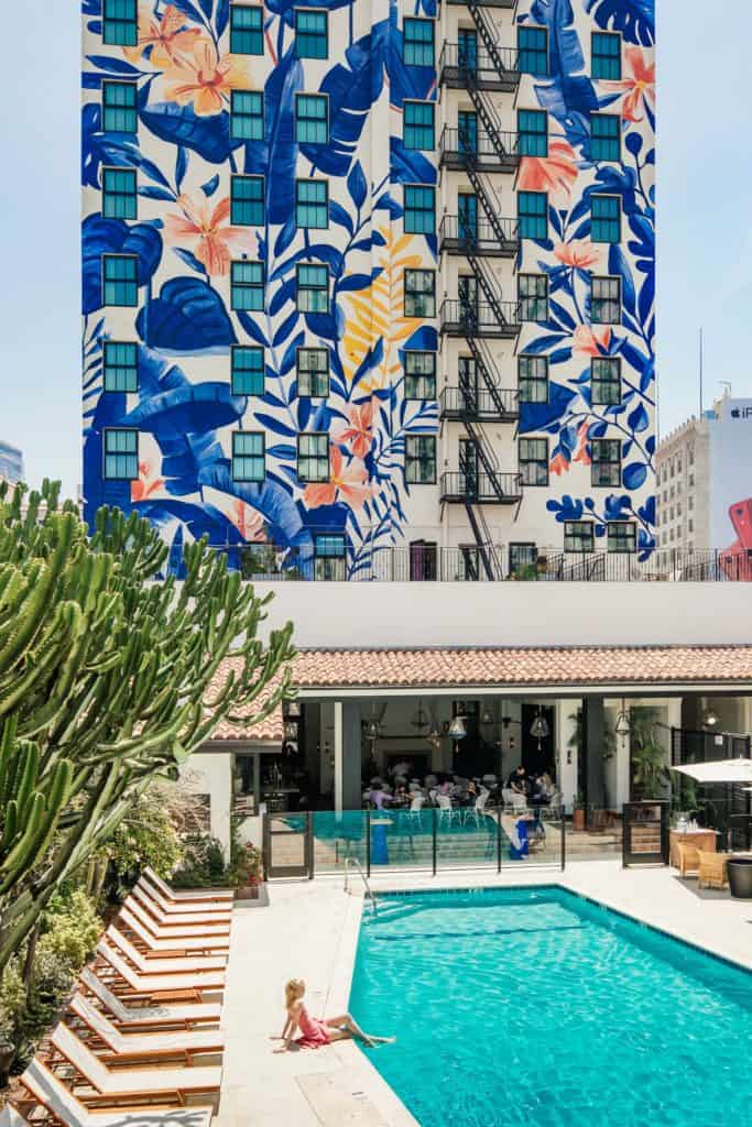 The coffin-shaped pool and Bella Gomez mural at the Hotel Figueroa