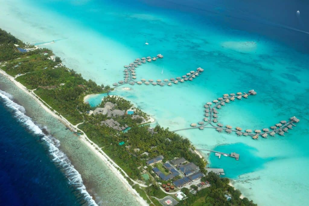 An aerial view of a collection of overwater bungalows