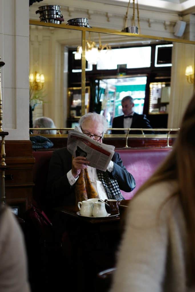 A man reads at Paris's Les Deux Magots café