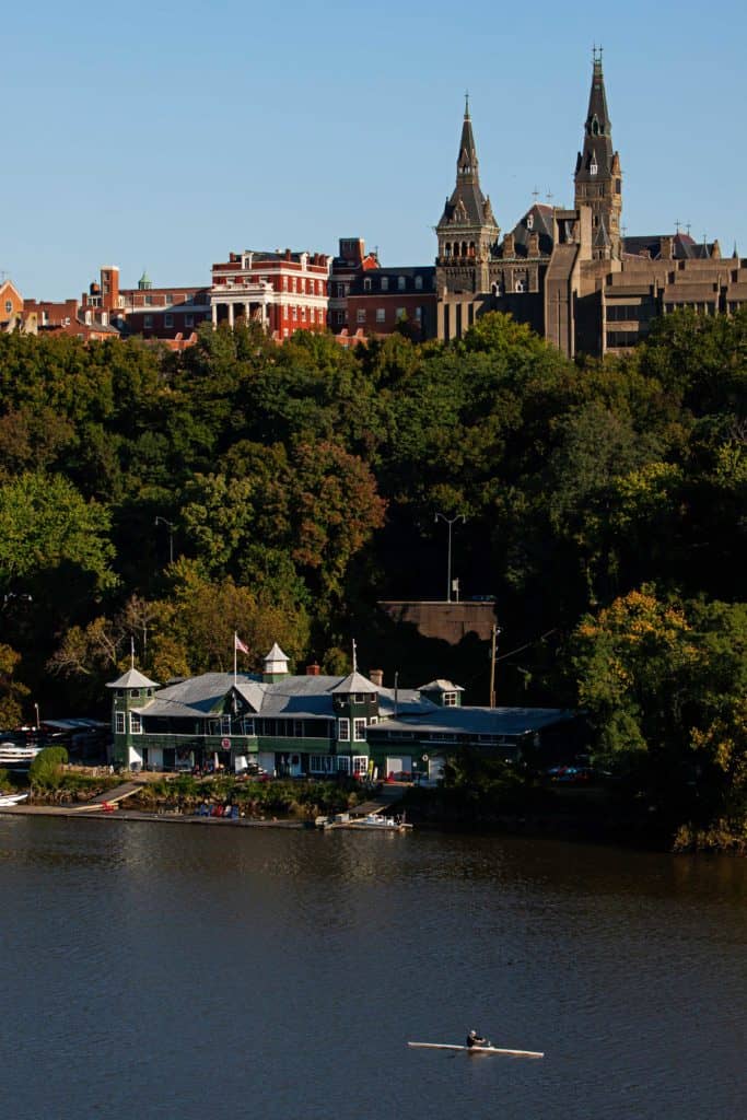 A rower on the Potomac River, with Georgetown University in the background