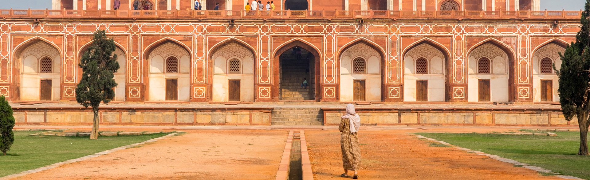 A woman stands by Delhi's Humayun's Tomb