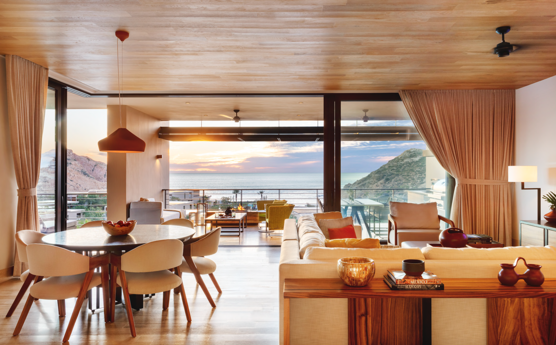An open-plan lounge and dining room looking out onto the ocean