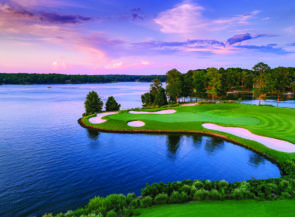 A golf course surrounded by a large lake