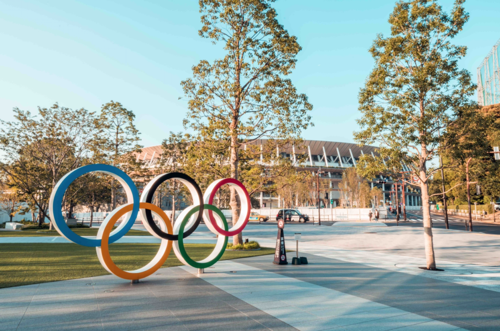 The Olympic Rings in front of a stadium.