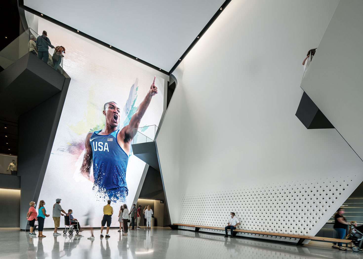 A large museum hall with a picture of an athlete on the wall.