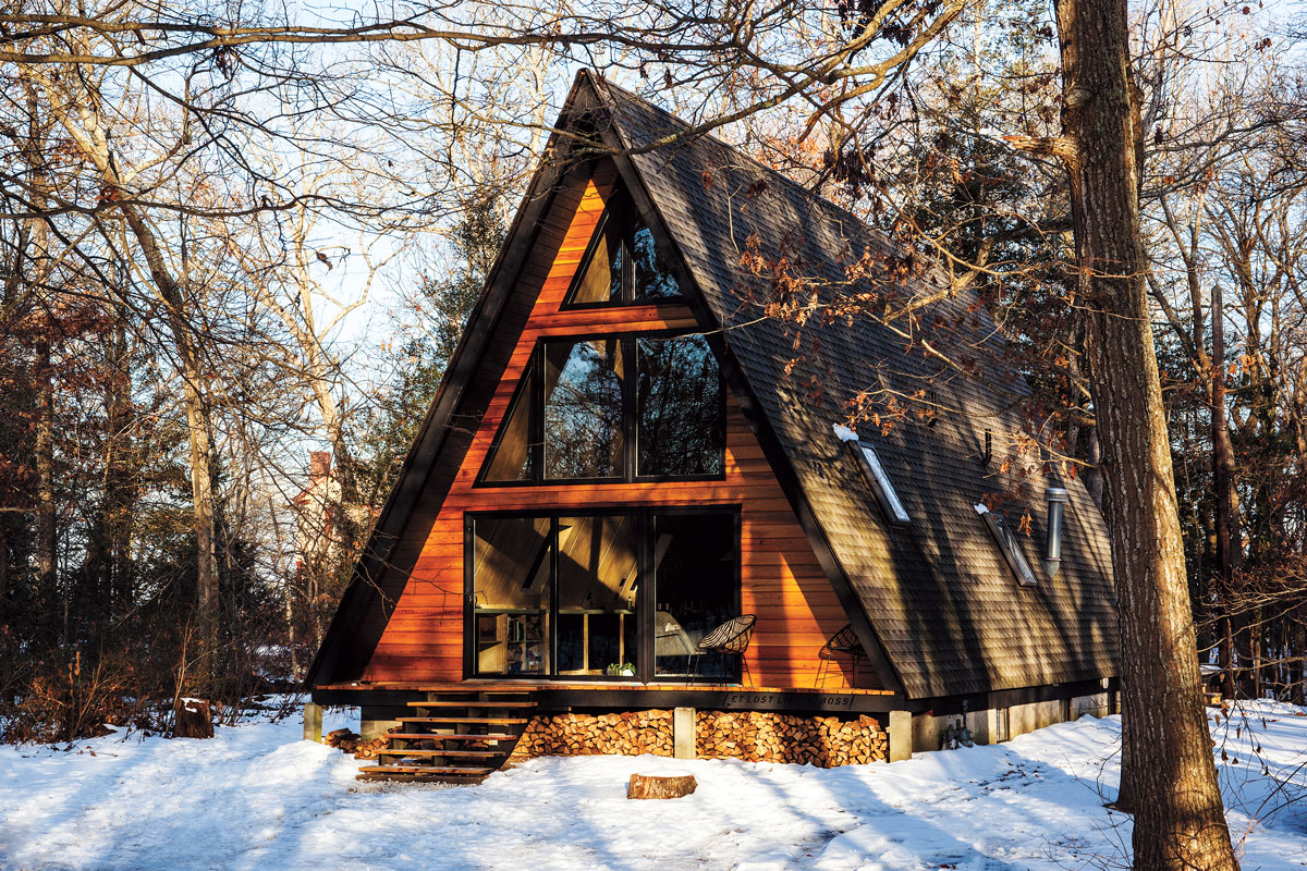 An A-frame cabin in a snowy forest