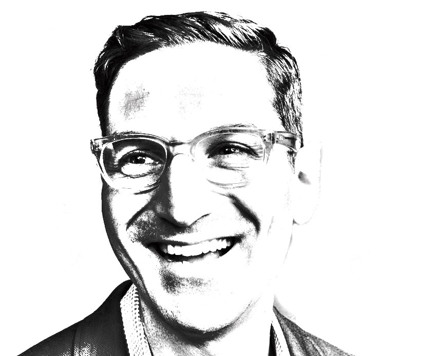 A black and white portrait of a man (Guy Raz) in glasses.