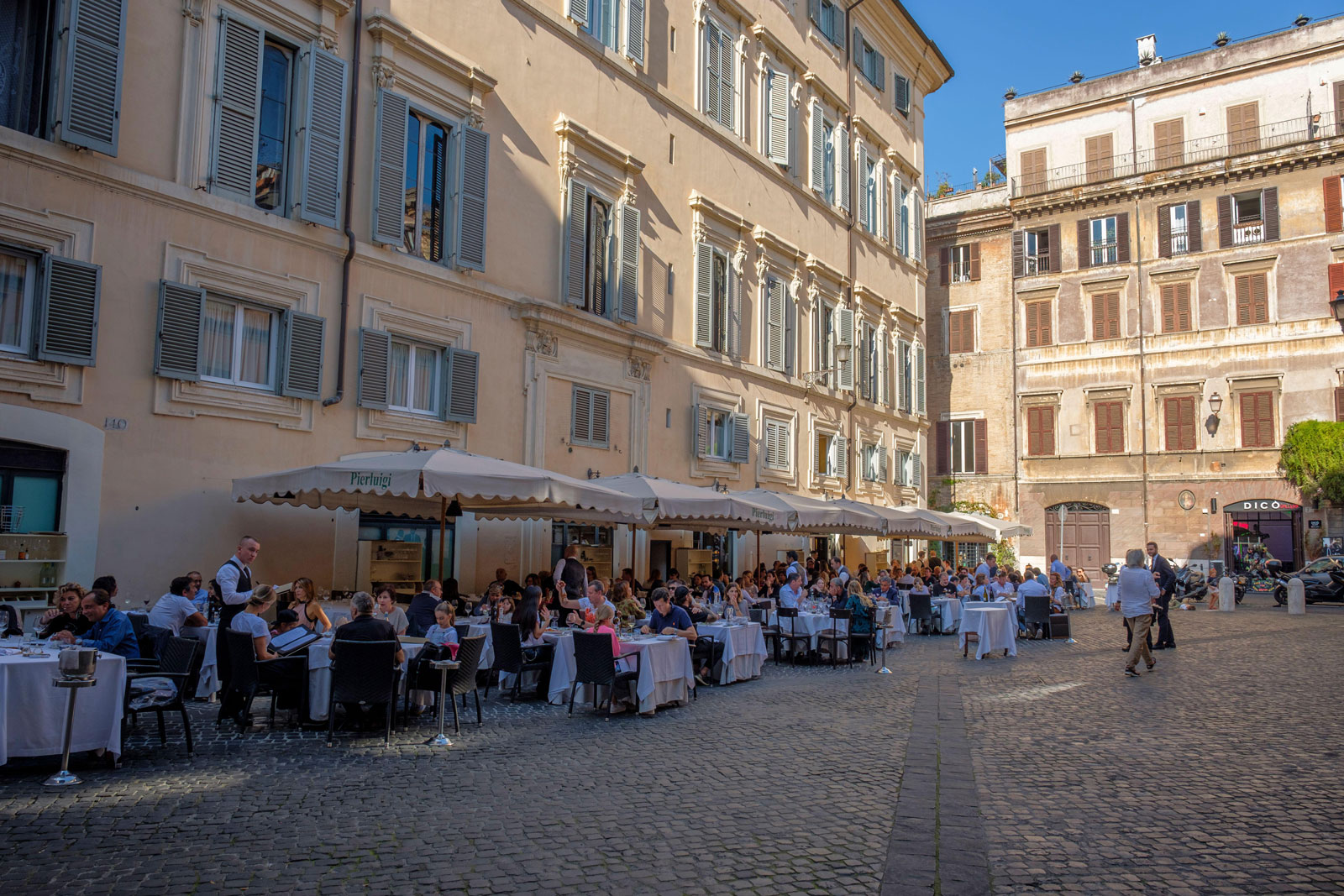 Seating outside a restaurant in a Roman Piazza.