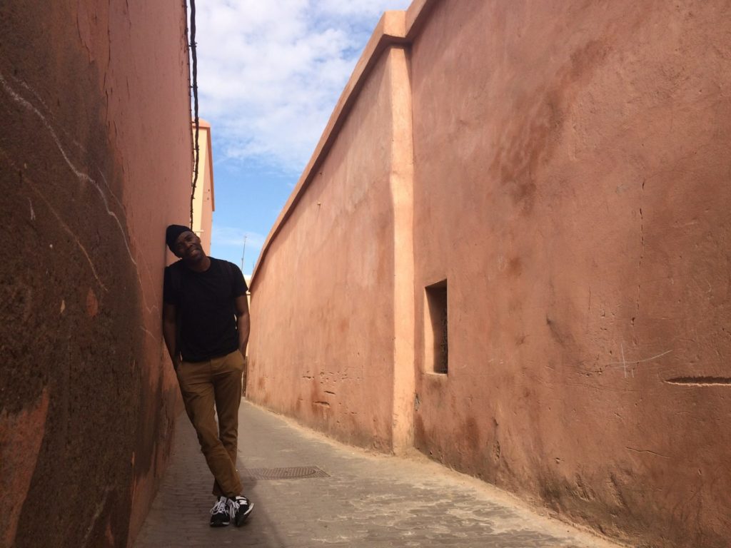 Man leans against a wall.