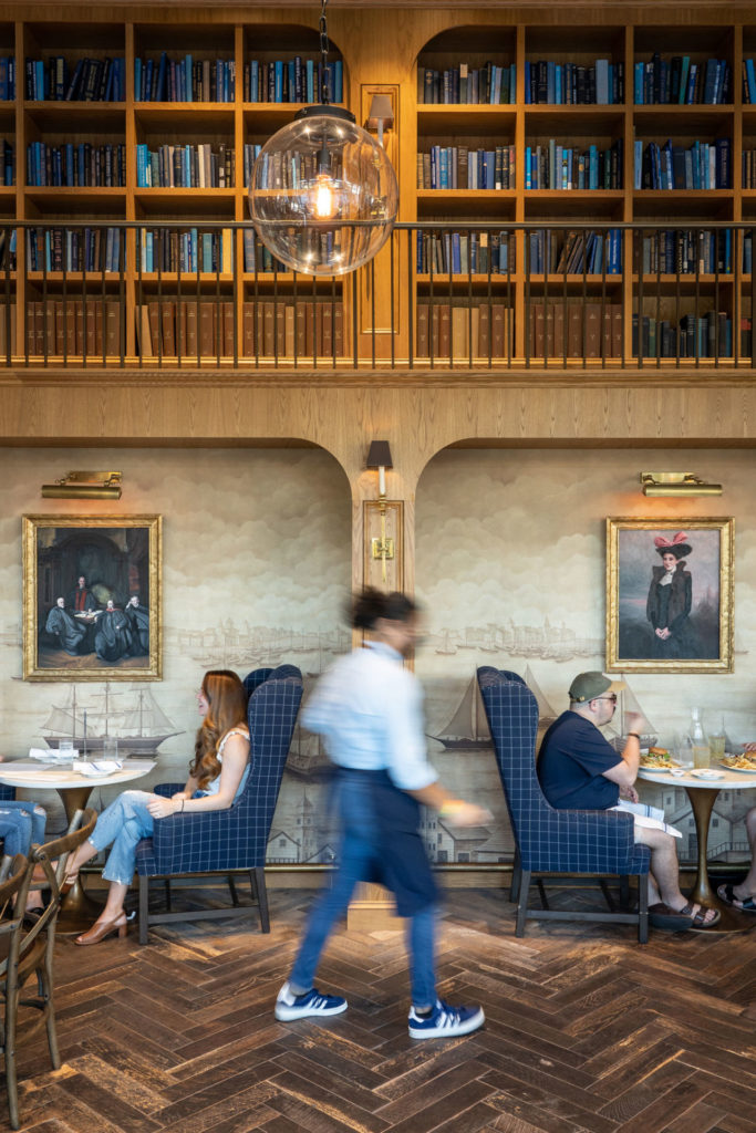 A restaurant with a beautiful book-lined dining room