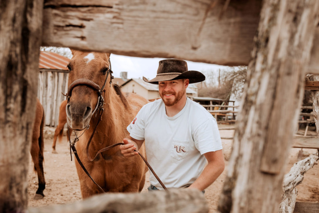 A man with a horse at a Texan ranch