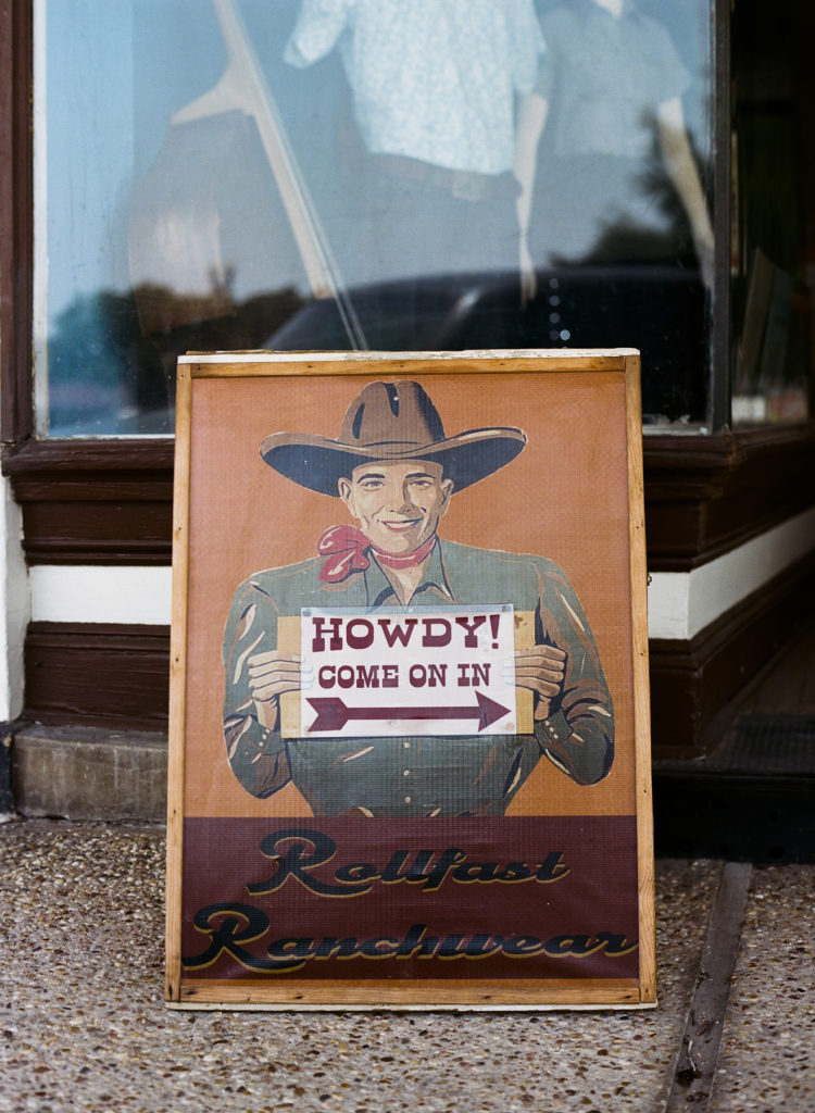 A shop sign with a cowboy