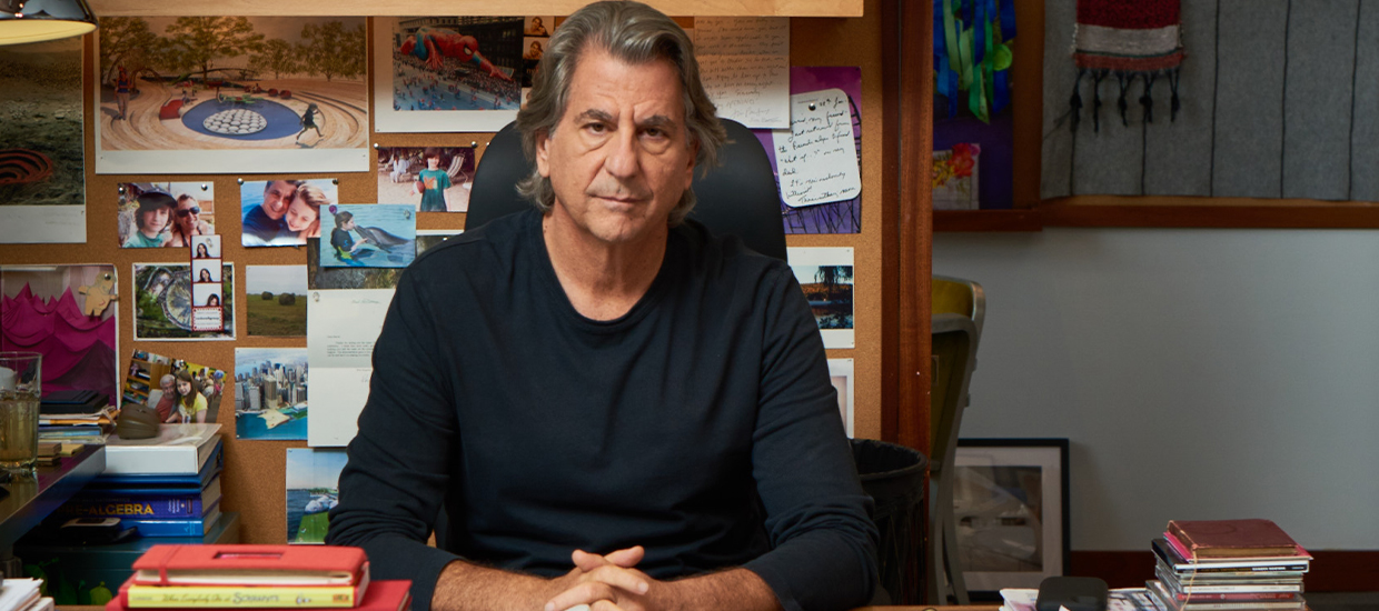 Designer David Rockwell sits at his colorful desk
