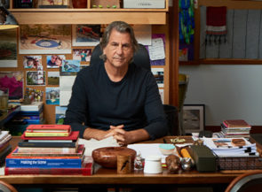 Designer David Rockwell sits at his colorful desk