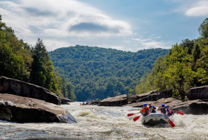 A family white water rafting in New River Gorge National Park and Preserve